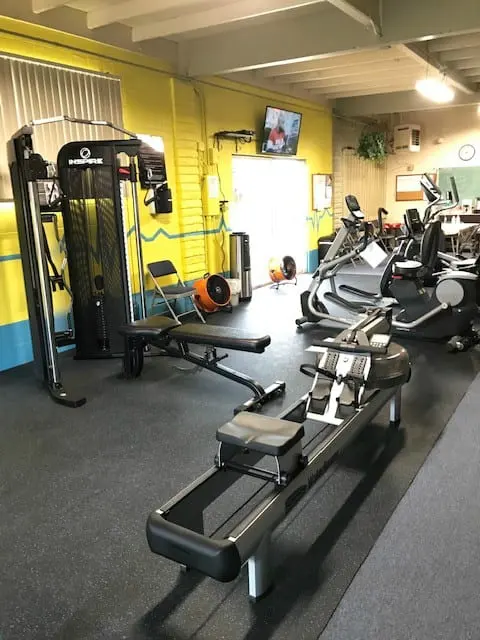 The fitness center rowing machine, bench, and multi-gym