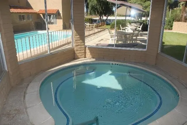 The covered indoor spa, with the pool and patio beyond